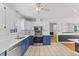 Well-lit kitchen with stainless appliances, tile floors, and white cabinets at 5328 Trackway Dr, Knightdale, NC 27545
