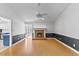 Bright living room features a brick fireplace, hardwood floors, ceiling fan, and modern decor at 5328 Trackway Dr, Knightdale, NC 27545
