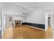 Bright living room featuring a brick fireplace, hardwood floors, ceiling fan, and fresh, neutral paint at 5328 Trackway Dr, Knightdale, NC 27545