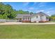 Spacious grassy lawn and a full view of the rear exterior of the home with a covered porch at 5328 Trackway Dr, Knightdale, NC 27545