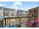 Balcony view of similar townhouse units, sky, and decorative colorful hanging planters at 5430 Crescent Square St, Raleigh, NC 27616