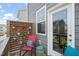 Balcony features chairs, a decorative privacy screen with colorful potted plants, and a door to the interior at 5430 Crescent Square St, Raleigh, NC 27616