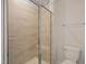 Bathroom showcasing the tiled shower with glass doors, a built-in seat, and a toilet at 5430 Crescent Square St, Raleigh, NC 27616