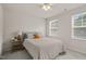 Bedroom with carpet, a ceiling fan, a bed, and two windows at 5430 Crescent Square St, Raleigh, NC 27616