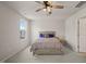 This bedroom features neutral walls and carpet, a ceiling fan, and a wood-look bed frame at 5430 Crescent Square St, Raleigh, NC 27616