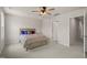 This bedroom features neutral walls and carpet, a ceiling fan, and a wood-look bed frame at 5430 Crescent Square St, Raleigh, NC 27616