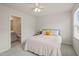 Bedroom with carpet, a ceiling fan, a bed, and view of the bathroom at 5430 Crescent Square St, Raleigh, NC 27616