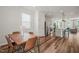 Bright dining area features wood floors and a view of the kitchen and living area in an open layout at 5430 Crescent Square St, Raleigh, NC 27616