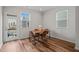 Bright dining area featuring wood floors, four chairs, and an adjacent doorway to a deck at 5430 Crescent Square St, Raleigh, NC 27616
