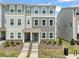 Attractive townhouse with manicured landscaping, visible in this sunny exterior view at 5430 Crescent Square St, Raleigh, NC 27616