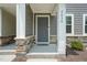 Inviting front entrance with a stone-accented porch and craftsman-style door at 5430 Crescent Square St, Raleigh, NC 27616