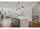 Spacious kitchen island with stainless steel appliances, with views to the living room and staircase at 5430 Crescent Square St, Raleigh, NC 27616