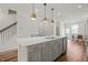 Open-concept kitchen with a large island, pendant lighting, and modern finishes at 5430 Crescent Square St, Raleigh, NC 27616