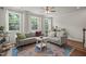 Cozy living room with large windows, hardwood floors, comfortable seating, and stylish decor at 5430 Crescent Square St, Raleigh, NC 27616