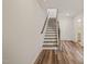Staircase with carpeted steps and wood-look floors that provide an open transition at 5430 Crescent Square St, Raleigh, NC 27616