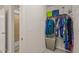 Walk-in closet featuring shelving and racks for ample storage, with a partial view of a bathroom at 5430 Crescent Square St, Raleigh, NC 27616
