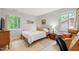 Cozy bedroom with light walls, two windows with natural light, a dresser and comfortable furniture at 60 Stoneridge Rd, Durham, NC 27705