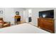 Bedroom featuring wood floors, bureau with TV, and adjacent vanity and bathroom at 60 Stoneridge Rd, Durham, NC 27705