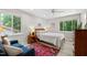 Bright bedroom featuring light wood floors, large windows, and comfortable furnishings at 60 Stoneridge Rd, Durham, NC 27705