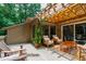 Cozy deck area with comfortable seating, a pergola, and lush greenery at 60 Stoneridge Rd, Durham, NC 27705