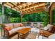 Relaxing deck area featuring comfortable seating, wooden furniture, and a pergola at 60 Stoneridge Rd, Durham, NC 27705