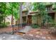 Inviting home exterior with a red front door, black iron railing, and a mulched and landscaped front yard at 60 Stoneridge Rd, Durham, NC 27705