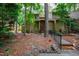 Charming front entrance of a home nestled among mature trees and landscaping at 60 Stoneridge Rd, Durham, NC 27705