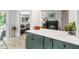 Open kitchen layout with marble countertops and green cabinetry, connecting to living spaces at 60 Stoneridge Rd, Durham, NC 27705