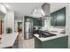 Modern kitchen features sleek appliances, white countertops, and chic green cabinets at 60 Stoneridge Rd, Durham, NC 27705