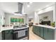 Updated kitchen with a marble countertop island and stainless steel appliances with access to the deck and living room at 60 Stoneridge Rd, Durham, NC 27705