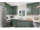 Kitchen with stainless steel appliances, modern green cabinetry, and a subway tile backsplash at 60 Stoneridge Rd, Durham, NC 27705