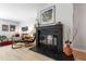 Bright living room with a black fireplace, modern furniture, and light-colored floors at 60 Stoneridge Rd, Durham, NC 27705
