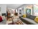 Stylish living room with modern gray sofa and decor, fireplace, and a seamless transition to outdoor deck at 60 Stoneridge Rd, Durham, NC 27705