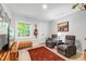Relaxing living room featuring wood floors, natural light, and comfortable furnishings at 60 Stoneridge Rd, Durham, NC 27705