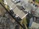 Aerial view of townhome complex with parking, green space, and mature trees at 610 Walnut Woods Dr, Morrisville, NC 27560