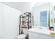 Clean bathroom featuring a white vanity, decorative shelving, and a shower with a curtain at 610 Walnut Woods Dr, Morrisville, NC 27560