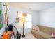 Cozy bedroom featuring guitars, a lamp, sofa, and window at 610 Walnut Woods Dr, Morrisville, NC 27560