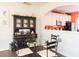 Cozy dining area features a glass table and ornate hutch, complemented by an open kitchen at 610 Walnut Woods Dr, Morrisville, NC 27560