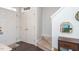 Bright entryway with white doors, hardwood floors, and carpeted stairs, creating a clean and inviting welcome at 610 Walnut Woods Dr, Morrisville, NC 27560
