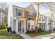 Two-story townhouse with a mix of gray siding and brick, featuring a well-manicured lawn at 610 Walnut Woods Dr, Morrisville, NC 27560