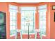 Cozy kitchen nook with a glass-top table, seating for two, and natural light from the bay window at 610 Walnut Woods Dr, Morrisville, NC 27560