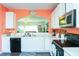 Sunny kitchen with white cabinets, stainless steel microwave, and open view to the living area at 610 Walnut Woods Dr, Morrisville, NC 27560