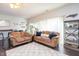 Inviting living room with hardwood floors, comfortable sofas, and ample natural light from the sliding glass door at 610 Walnut Woods Dr, Morrisville, NC 27560
