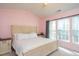 Light-filled main bedroom featuring a large bed, side tables and a bright window view at 610 Walnut Woods Dr, Morrisville, NC 27560