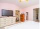 Inviting main bedroom with a dresser, television and en-suite bathroom entrance at 610 Walnut Woods Dr, Morrisville, NC 27560