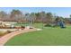 Community playground with climbing structures, slides, and artificial turf at 610 Walnut Woods Dr, Morrisville, NC 27560
