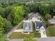 An aerial view showcases the property, neighborhood, and lush greenery surrounding the homes at 622 Sunset Ave, Apex, NC 27502