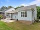Landscaped backyard with a patio, outdoor seating, and access to the screened porch at 622 Sunset Ave, Apex, NC 27502