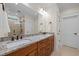 Bright bathroom featuring a double vanity with granite countertop, framed mirror, and tiled shower with glass door at 622 Sunset Ave, Apex, NC 27502