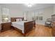 Comfortable bedroom with wood floors, and plenty of light from large windows with plantation shutters at 622 Sunset Ave, Apex, NC 27502